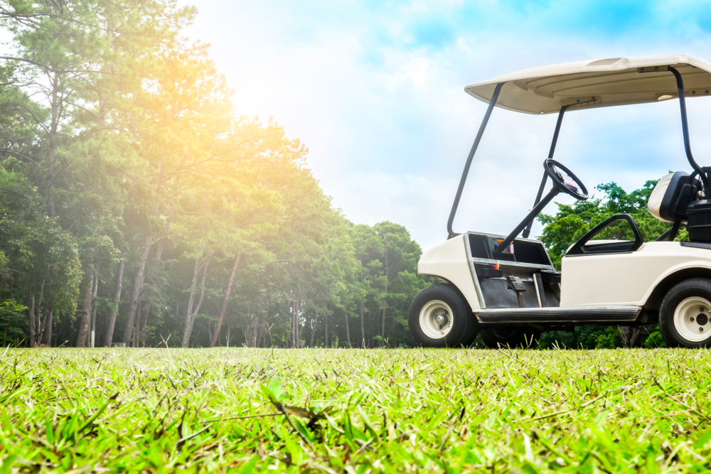Golf cart in a golf course requiring golf water recycling for cleaning