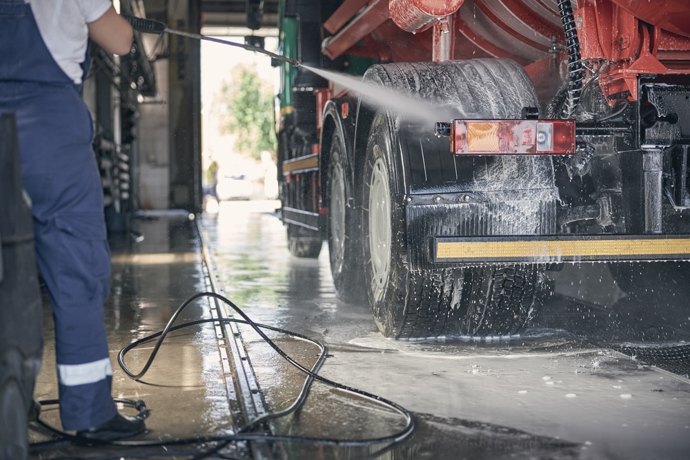 Staff washing a truck from a logistics company