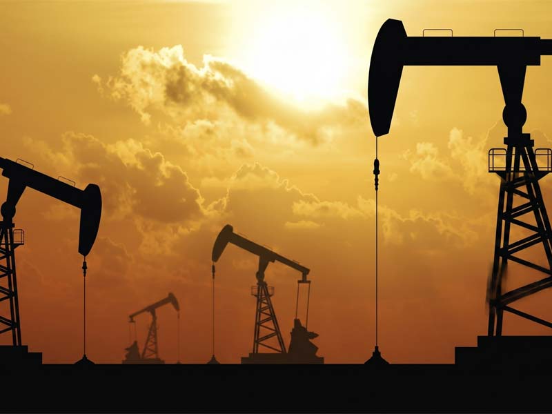 Dusk at an Oil Refinery With Many Oil Wells