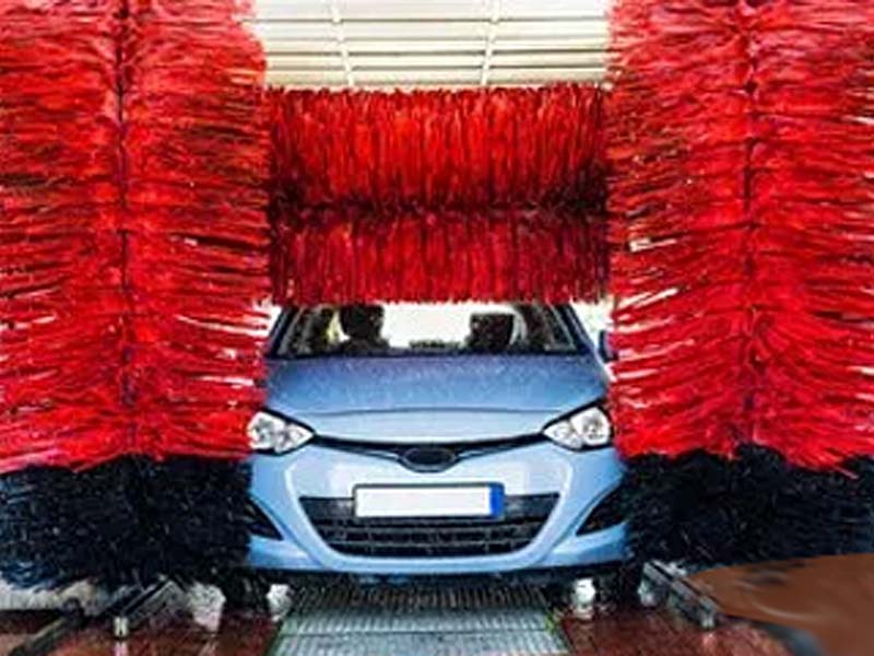 Blue Car Going Through a Wash Producing Wash Water